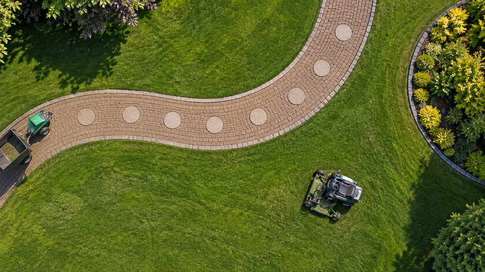 Illustration of a landscaped garden with lawns and a winding path